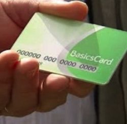 Picture of a hand holding a green credit card-sized card, with the words 'Basics Card' printed on it