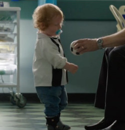 The boy who supposedly has Morquio's syndrome A young white boy with ginger hair, who supposedly has Morquio's syndrome, taking a football from a man (off the picture to the right)
